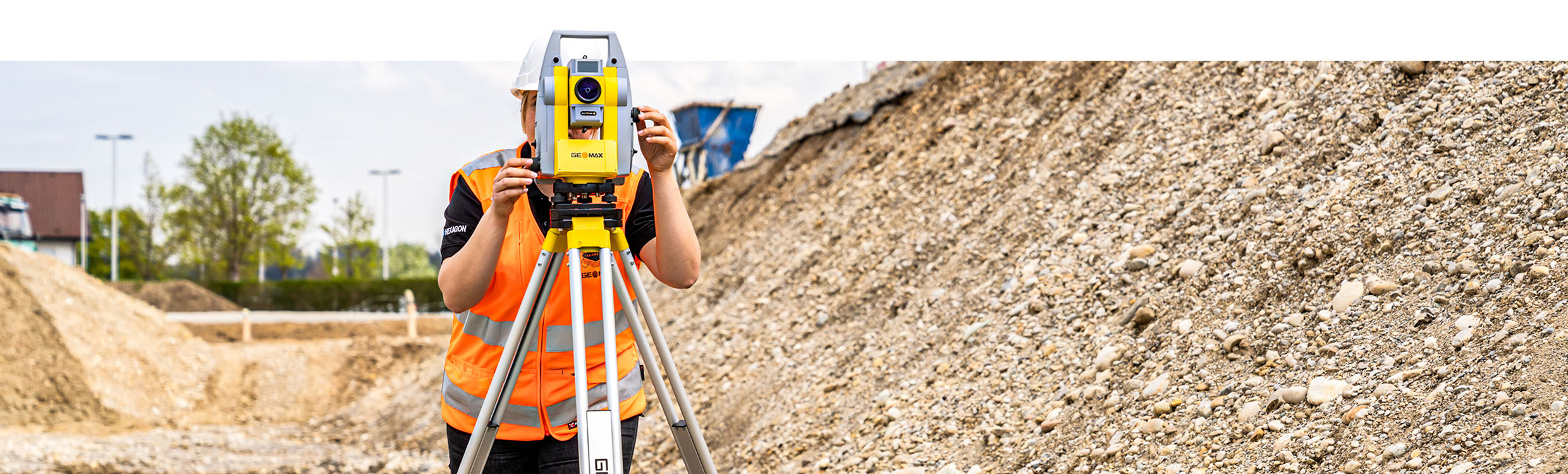 surveyor using the Geomax Zoom75 robotic total station out in the field